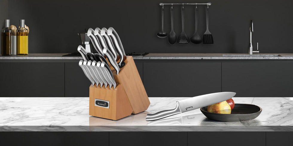 The Kuisine set of kitchen knives features ergonomic handles designed for comfort and control during use. Each handle is carefully weighted to provide a balanced feel, reducing hand fatigue while ensuring safety and efficiency in the kitchen. This comprehensive block of knives includes everything you need for efficient meal preparation. The kitchen knife block itself showcases impeccable craftsmanship and an elegant design, offering secure and stylish storage for all the knives in the set.